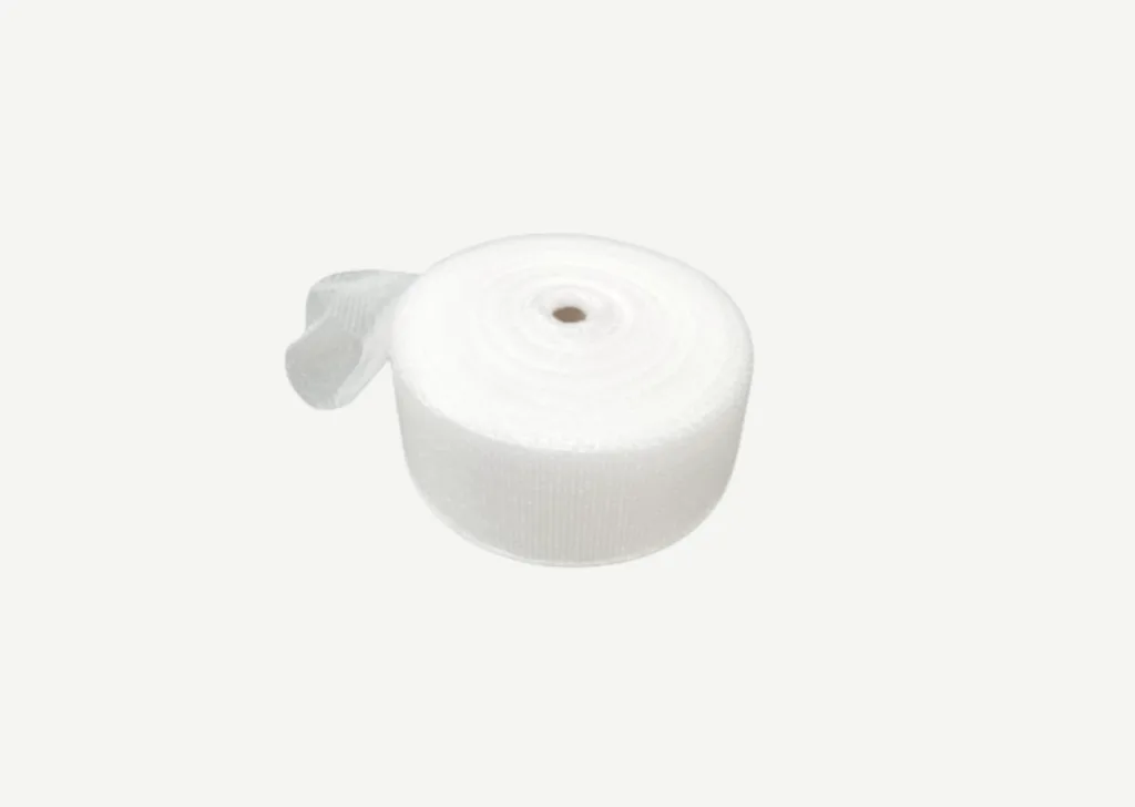 Bubble wrap sleeve rolled onto a roll, displayed on a gray background