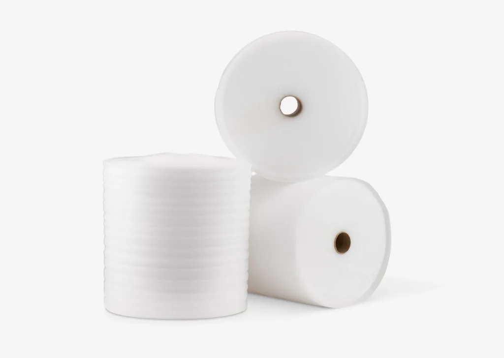 Three rolls of white polyethylene foam on a gray background