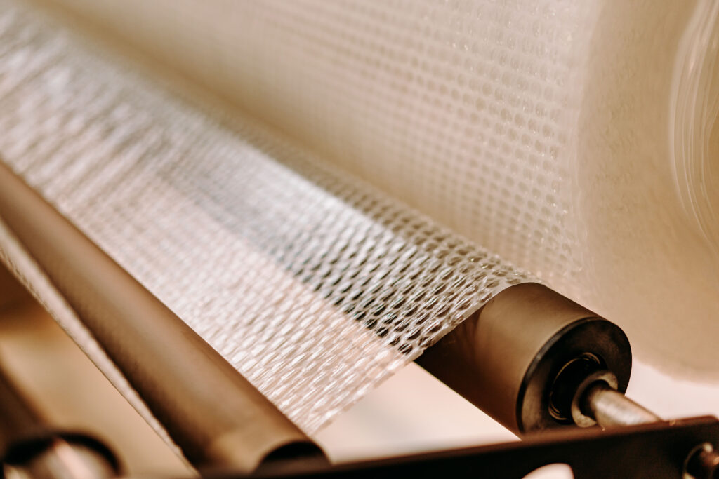 bubble wrap Bubble wrap being produced on the machine in the manufacturing process.