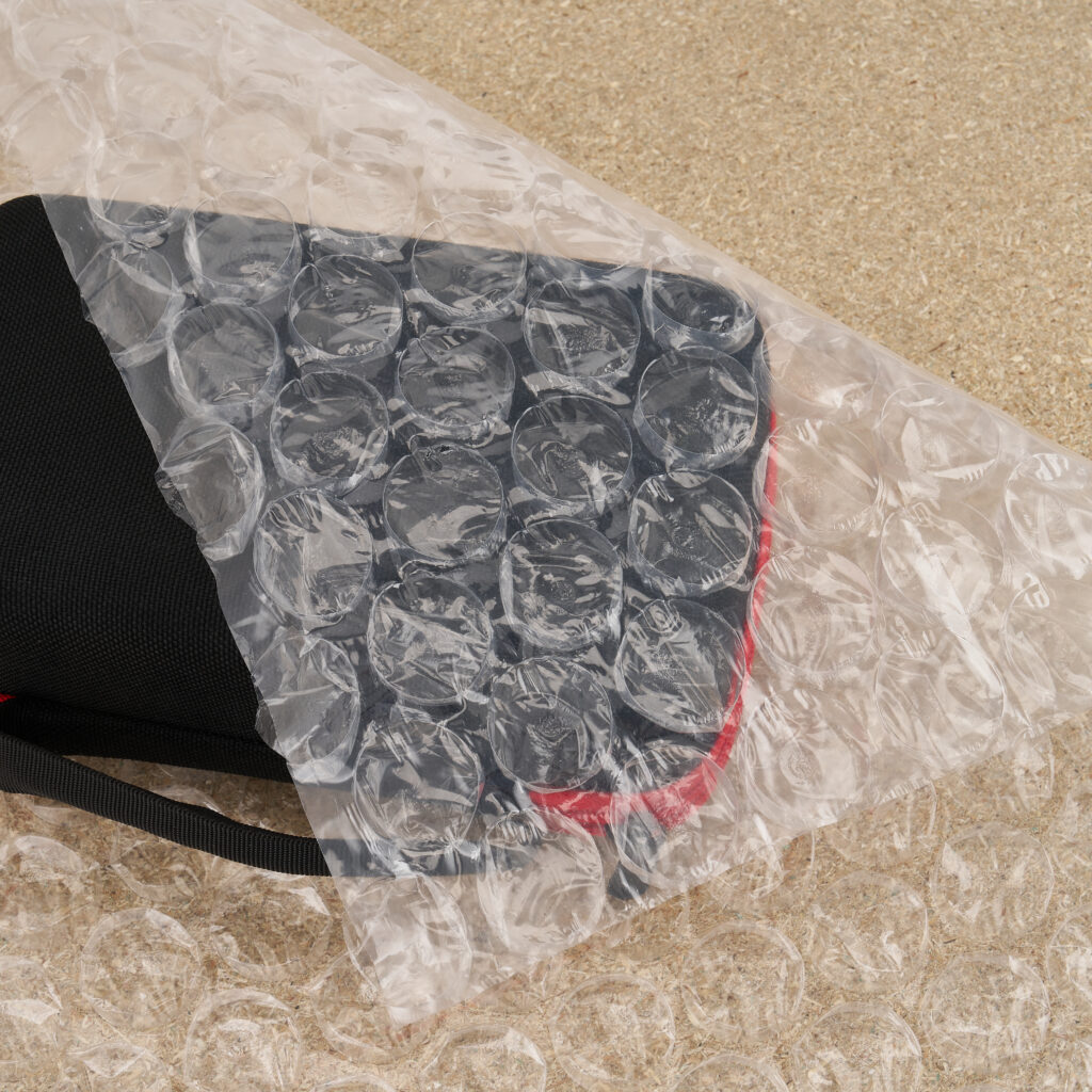 bubble-wrap-large-bubbles-packaging Protective packaging with large-bubble wrap used to secure a textile item during storage or transport