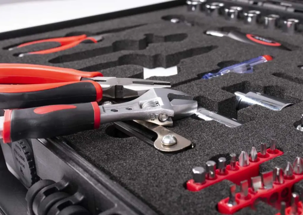 Custom black PE foam inserts with precision-cut shapes for protective packaging