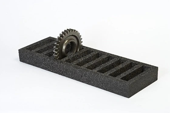 PE foam insert protecting a metal gear during transport and storage